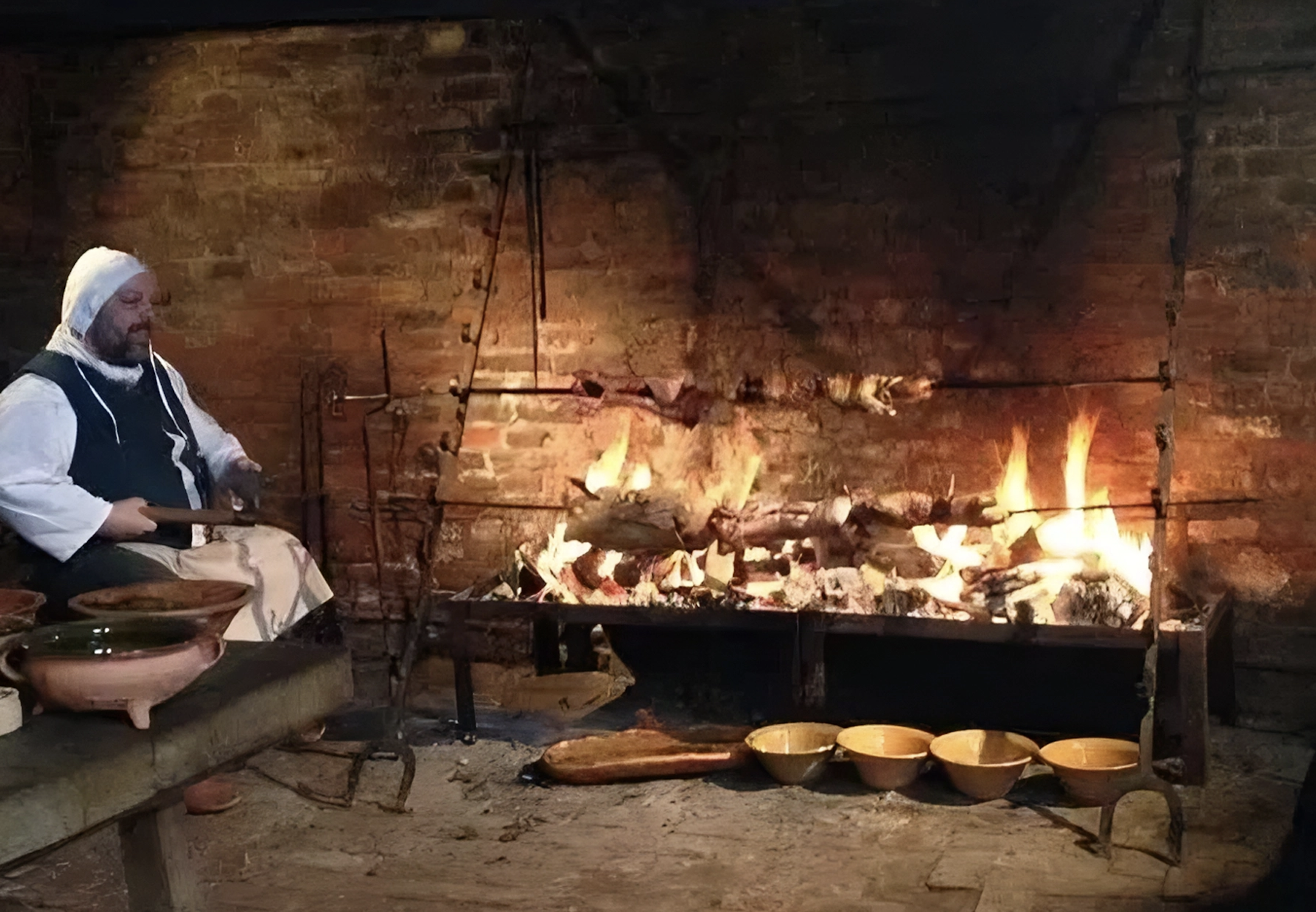 Grillen in einem Schlosskamin mit manuellen Spießdrehern