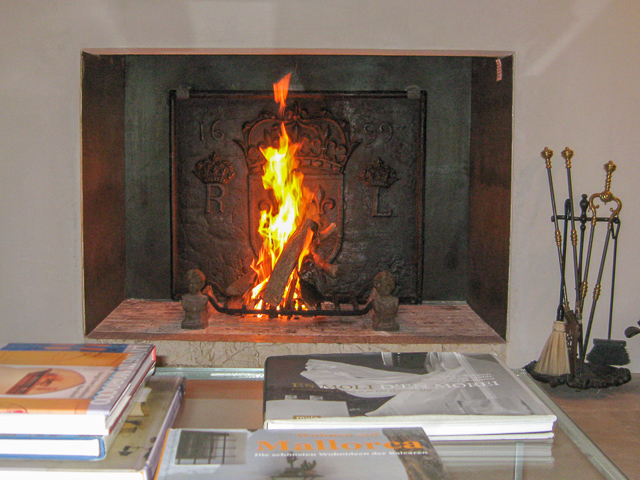 Ein moderner spanischer Kamin mit einer französischen Kaminplatte aus dem 17. Jahrhundert und Feuerböcken aus dem 19. Jahrhundert